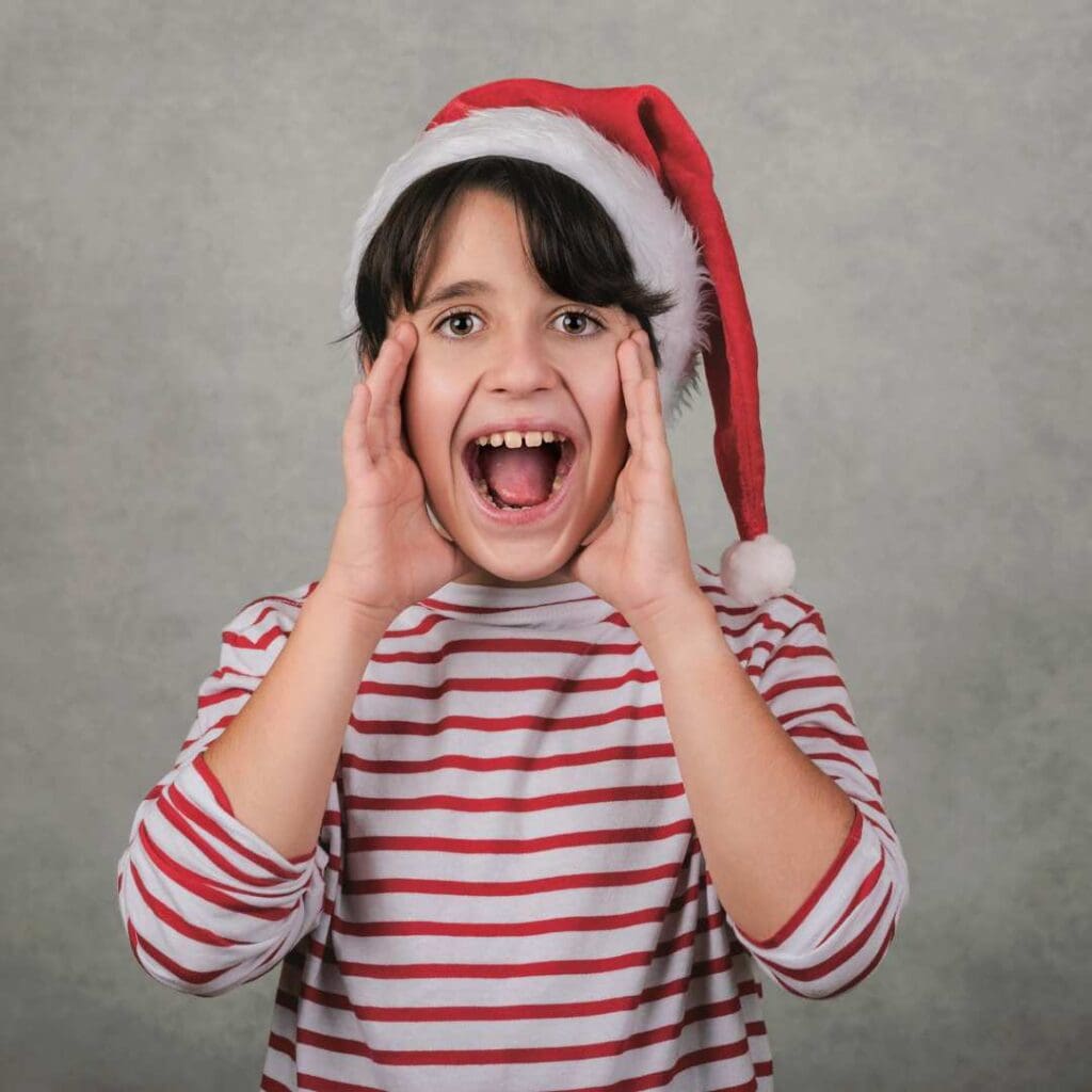 Image shows a screaming child dressed in a Santa hat. From a blog post titled Proven Holiday Classroom Management Strategies for Thriving Not Just Surviving by In Around the Middle @ aroundthemiddle.com
